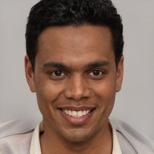Joyful white young-adult male with short  black hair and brown eyes