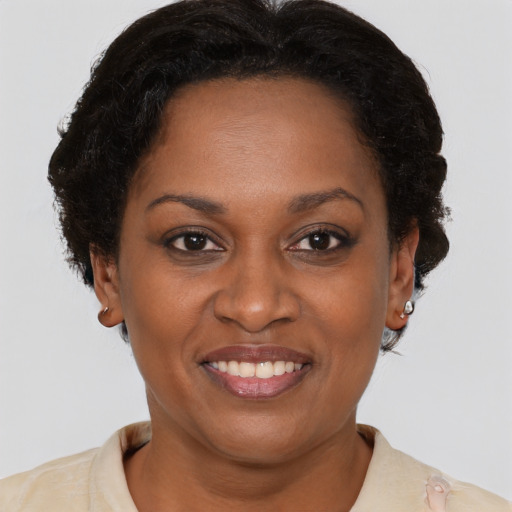 Joyful black adult female with short  brown hair and brown eyes