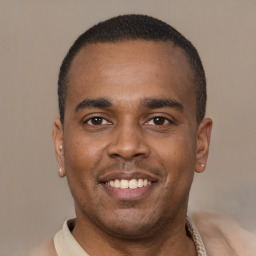 Joyful latino young-adult male with short  brown hair and brown eyes