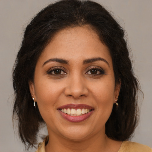 Joyful white young-adult female with medium  brown hair and brown eyes