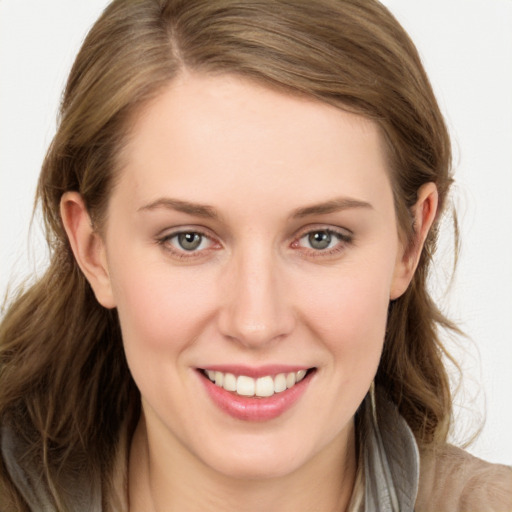 Joyful white young-adult female with long  brown hair and grey eyes