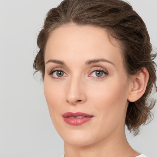 Joyful white young-adult female with medium  brown hair and green eyes