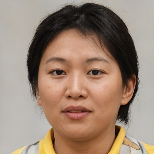 Joyful asian young-adult female with medium  brown hair and brown eyes