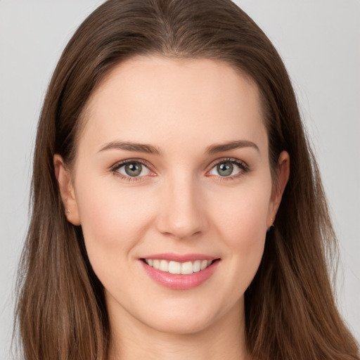 Joyful white young-adult female with long  brown hair and grey eyes