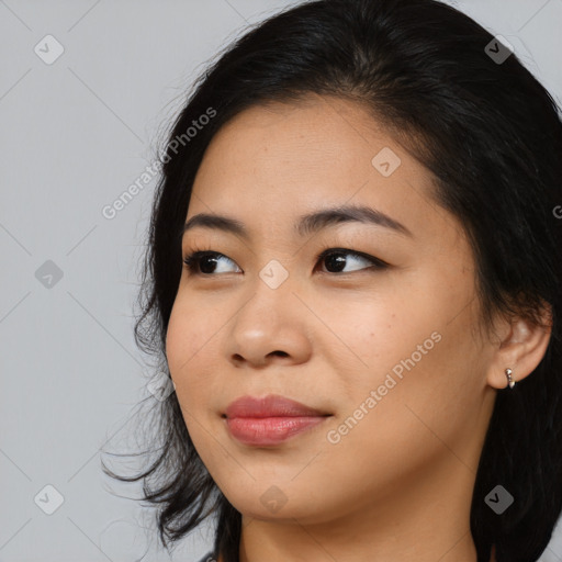 Joyful asian young-adult female with long  brown hair and brown eyes