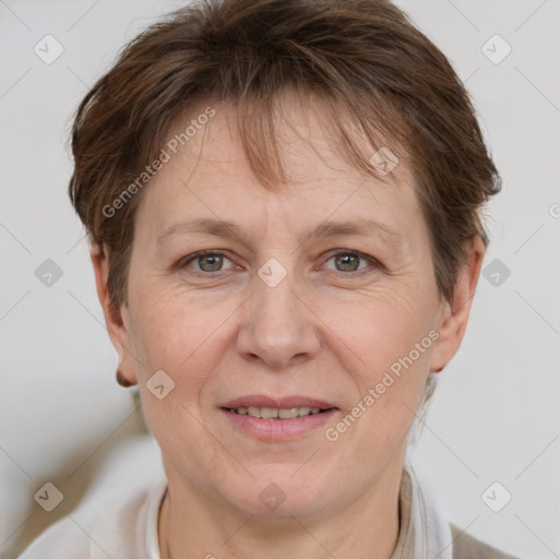 Joyful white adult female with short  brown hair and grey eyes