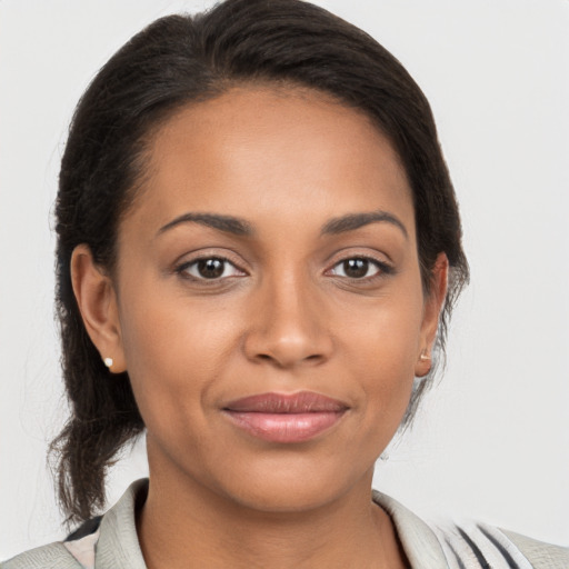 Joyful latino young-adult female with medium  brown hair and brown eyes