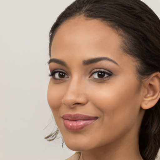 Joyful latino young-adult female with long  brown hair and brown eyes