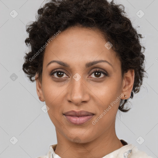 Joyful black adult female with short  brown hair and brown eyes