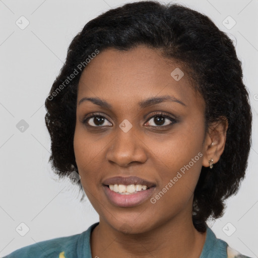 Joyful black young-adult female with short  black hair and brown eyes