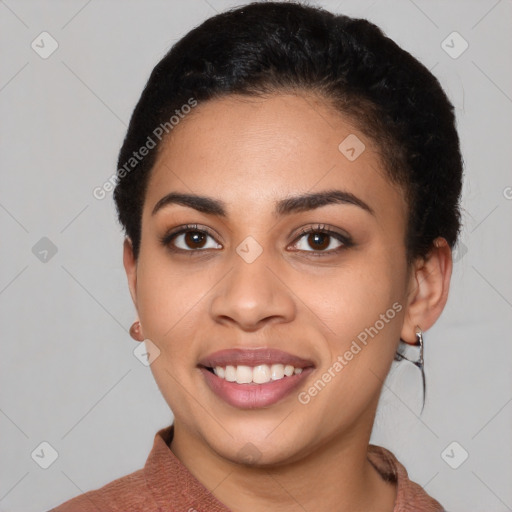 Joyful latino young-adult female with short  black hair and brown eyes