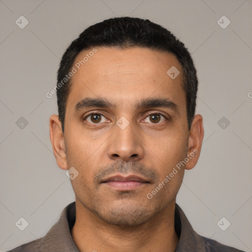 Neutral latino young-adult male with short  black hair and brown eyes