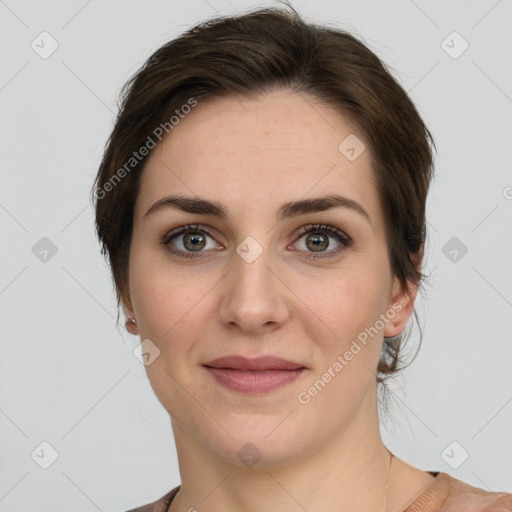 Joyful white young-adult female with medium  brown hair and green eyes