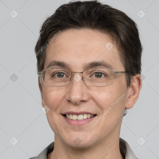 Joyful white adult male with short  brown hair and grey eyes