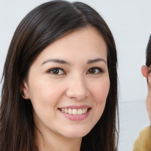 Joyful white young-adult female with long  brown hair and brown eyes