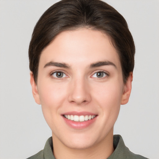 Joyful white young-adult female with short  brown hair and brown eyes