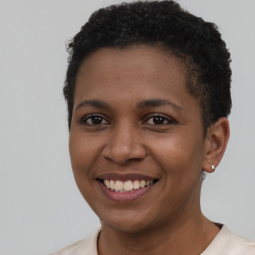 Joyful black young-adult female with short  brown hair and brown eyes