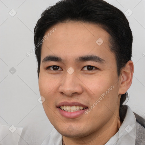 Joyful asian young-adult male with short  brown hair and brown eyes