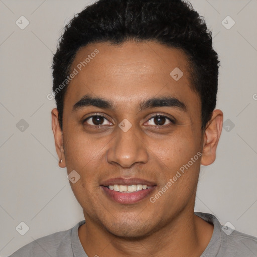 Joyful latino young-adult male with short  black hair and brown eyes