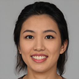 Joyful asian young-adult female with medium  black hair and brown eyes