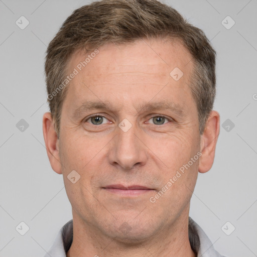 Joyful white adult male with short  brown hair and grey eyes