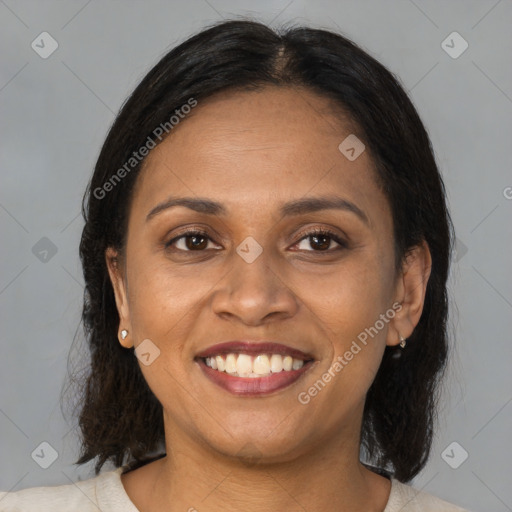 Joyful latino adult female with medium  brown hair and brown eyes