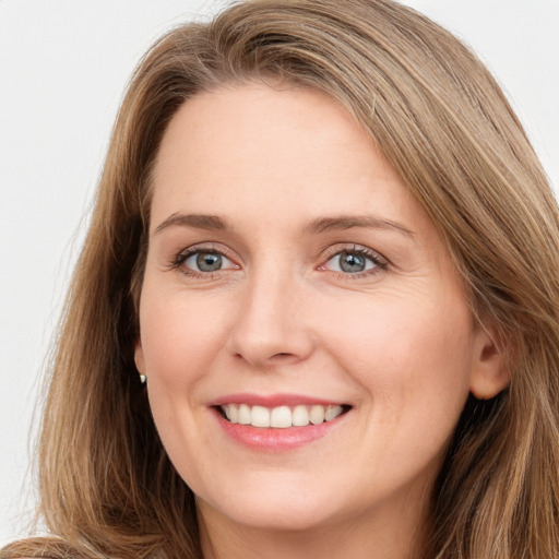 Joyful white young-adult female with long  brown hair and grey eyes