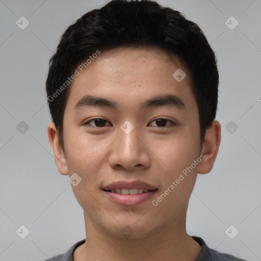 Joyful asian young-adult male with short  brown hair and brown eyes