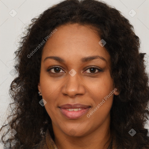 Joyful black young-adult female with long  brown hair and brown eyes