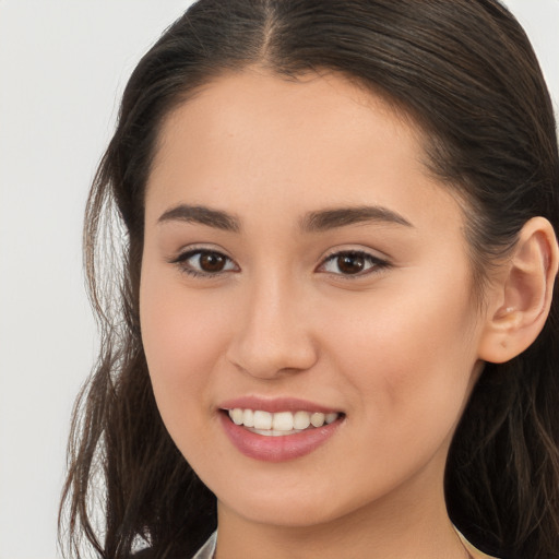 Joyful white young-adult female with long  brown hair and brown eyes