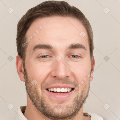 Joyful white young-adult male with short  brown hair and grey eyes