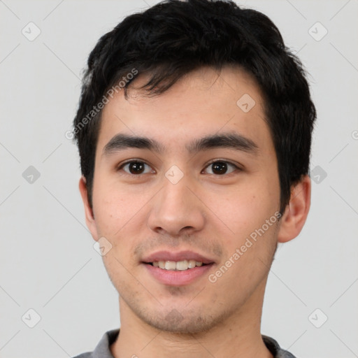 Joyful white young-adult male with short  black hair and brown eyes