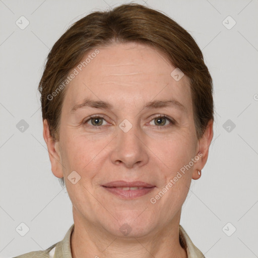 Joyful white adult female with short  brown hair and grey eyes