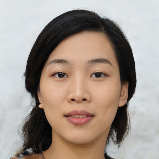 Joyful asian young-adult female with medium  black hair and brown eyes