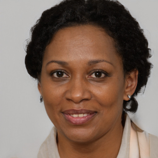 Joyful black adult female with short  brown hair and brown eyes