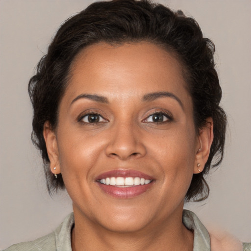 Joyful white adult female with medium  brown hair and brown eyes