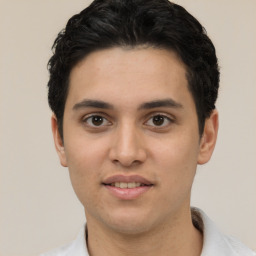 Joyful white young-adult male with short  black hair and brown eyes