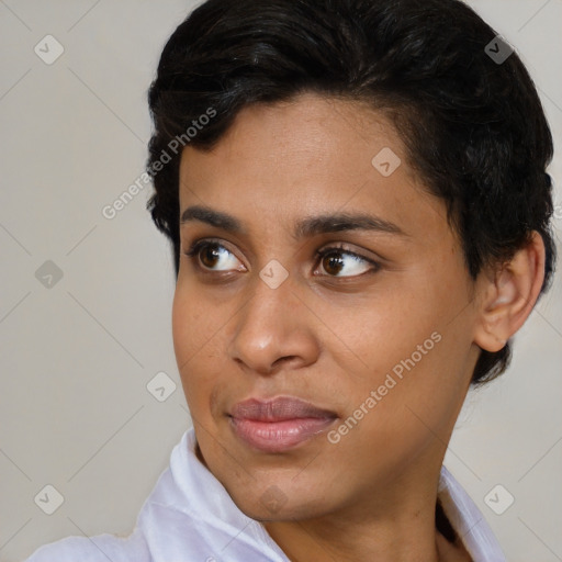 Joyful black young-adult female with short  brown hair and brown eyes