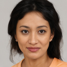 Joyful asian young-adult female with medium  brown hair and brown eyes