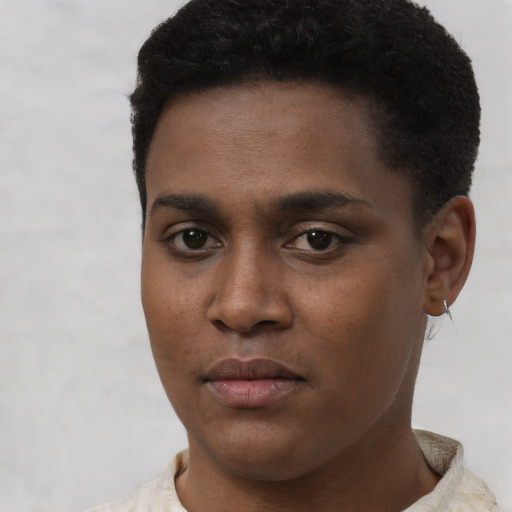Joyful black young-adult male with short  black hair and brown eyes