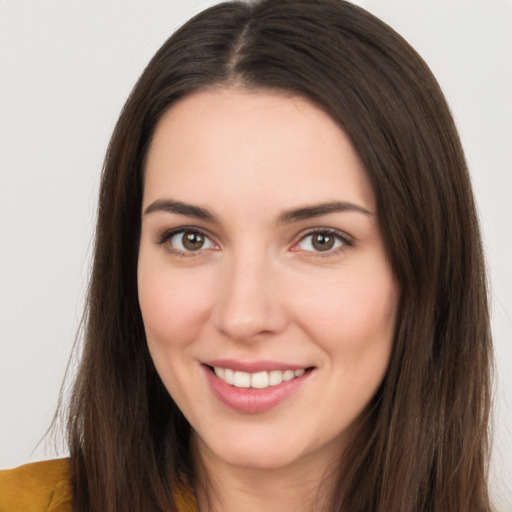 Joyful white young-adult female with long  brown hair and brown eyes