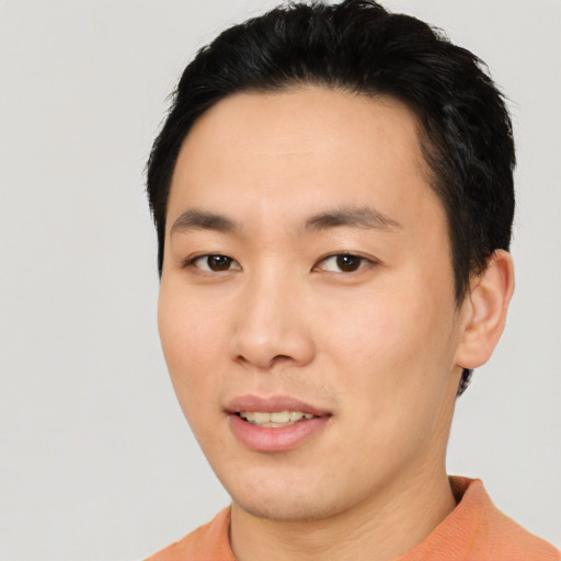 Joyful asian young-adult male with short  black hair and brown eyes