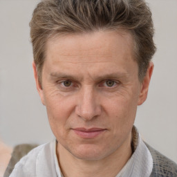 Joyful white adult male with short  brown hair and grey eyes