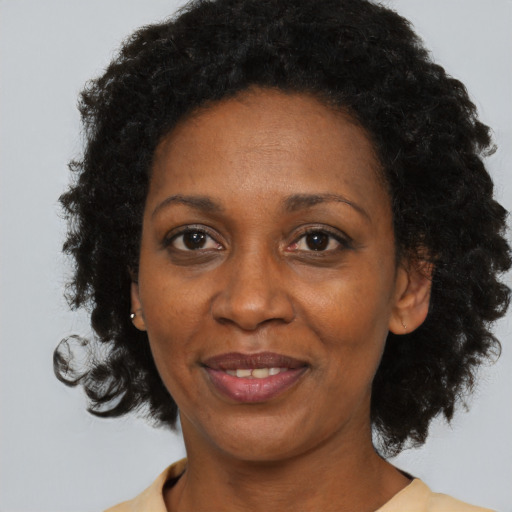 Joyful black adult female with short  black hair and brown eyes