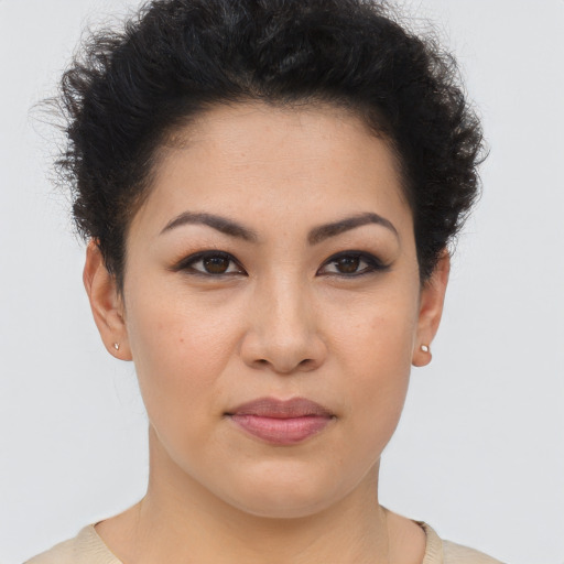 Joyful latino young-adult female with short  brown hair and brown eyes