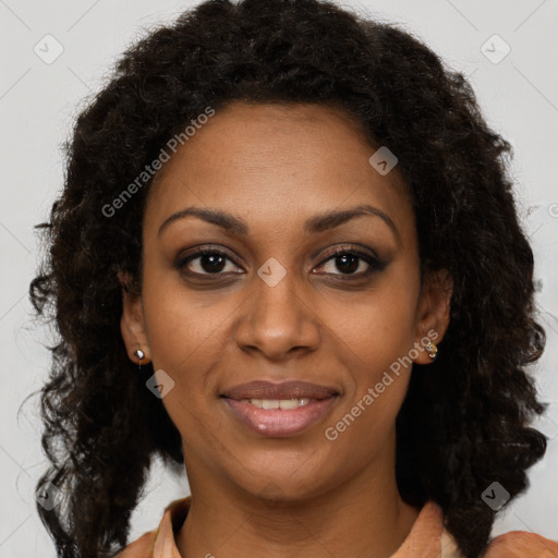 Joyful black young-adult female with long  brown hair and brown eyes