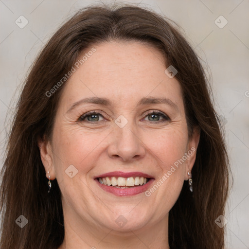 Joyful white adult female with long  brown hair and grey eyes