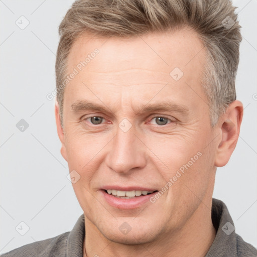 Joyful white adult male with short  brown hair and grey eyes