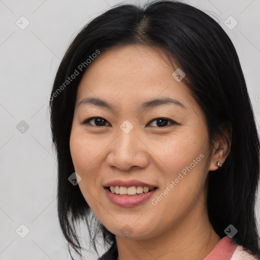 Joyful asian young-adult female with medium  black hair and brown eyes