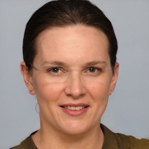 Joyful white adult female with short  brown hair and grey eyes